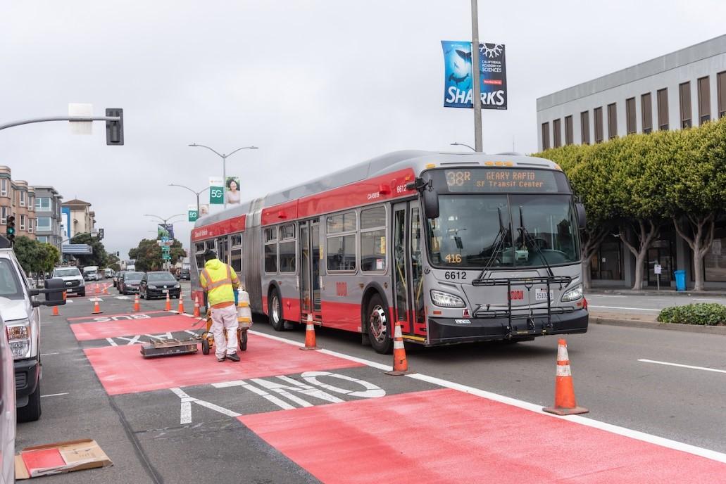 SFMTA paint shop crews install new red transit lanes on Geary Boulevard