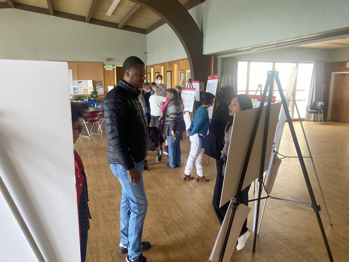Community members view posters and talk to staff at our May 9 open house.