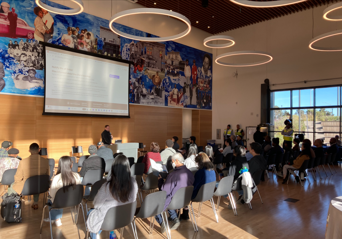 people listen in to a speaker during an opening plenary session at Community Connections