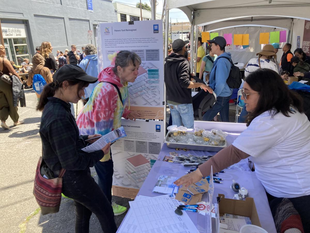 people looking at information during a street fair