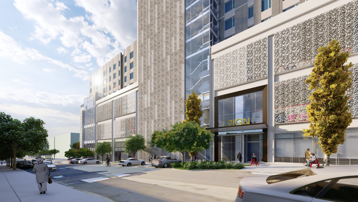 View of housing entrance with close-up of art opportunity and trees