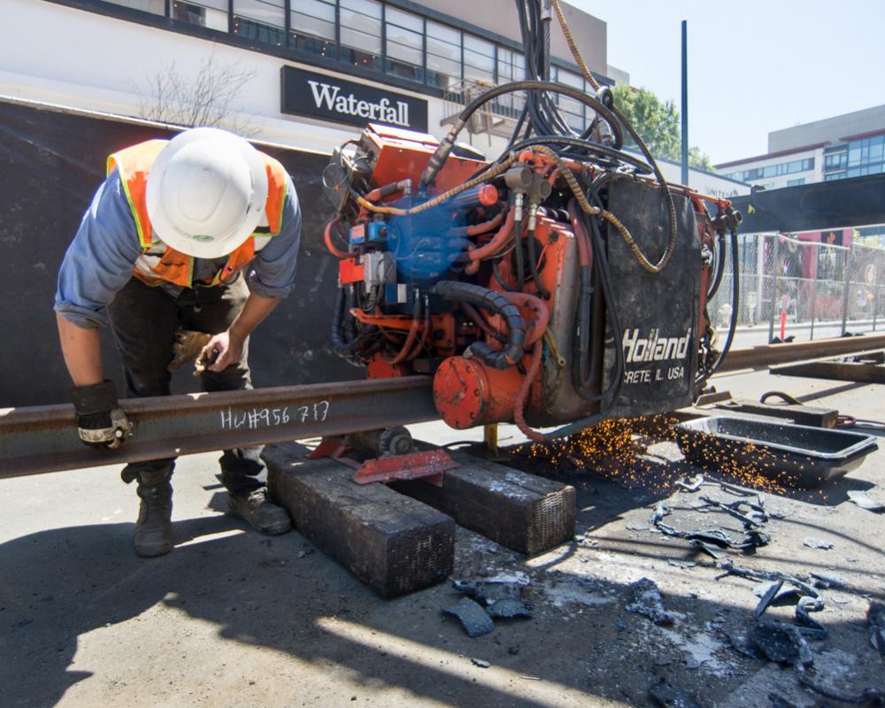 Two short sections of rail are welded together using this machine near 4th and Bluxome.