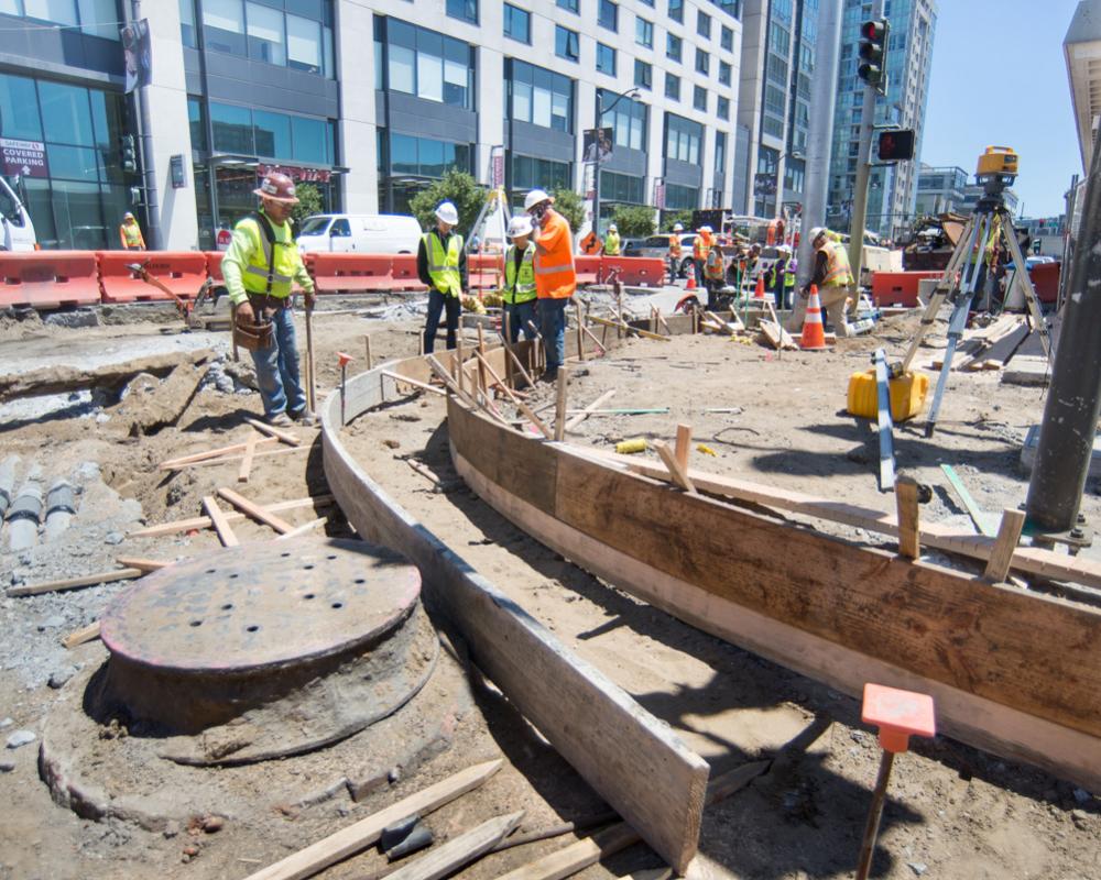 Curved formwork mark the edges of future curbs and gutters during sidewalk restoration work at 4th and Townsend.