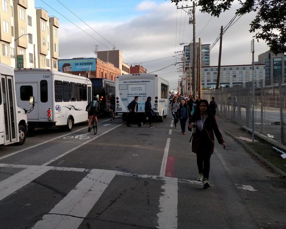 Photo of shuttles blocking and loading in the Townsend bike lane and no sidewalk for pedestrians - November 2016
