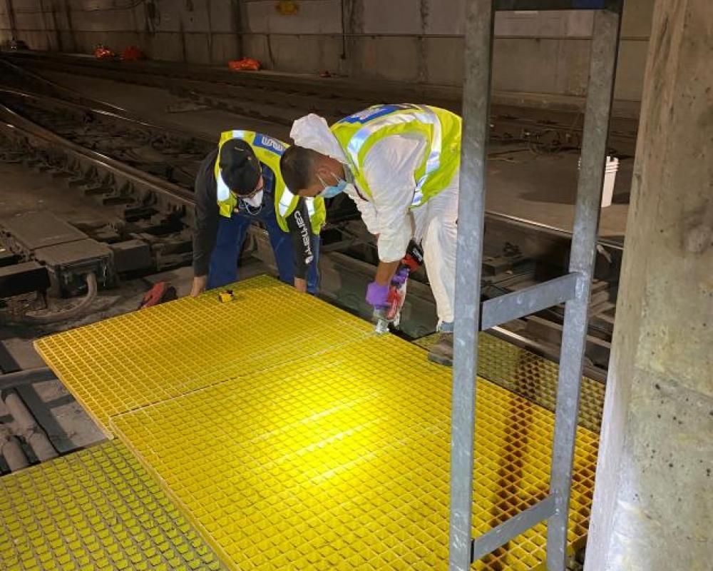 Subway engineers from Maintenance of Way install new floor grates