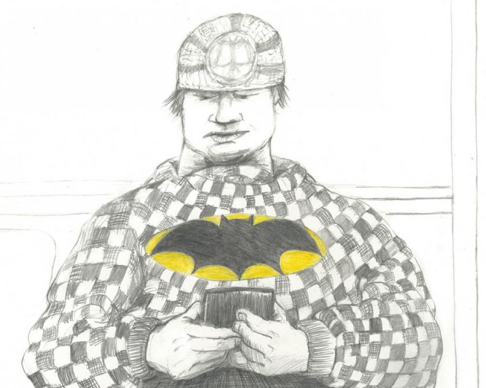 A black and white drawing of a man looking at a smartphone and wearing a shirt that has a yellow and black "Batman" logo.
