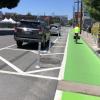 7th Street after: bicyclist riding in a protected bikeway with green paint