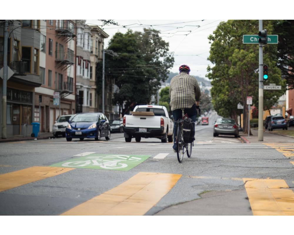 Man bicycling across Church street on 17th street
