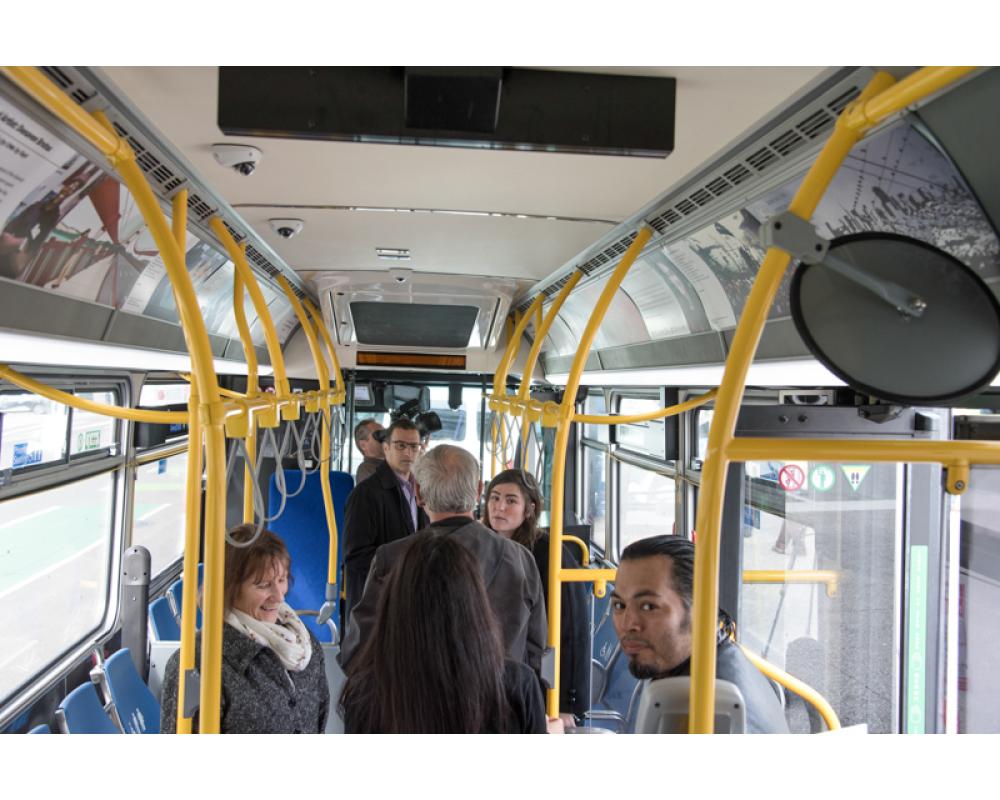 people looking at artwork in bus