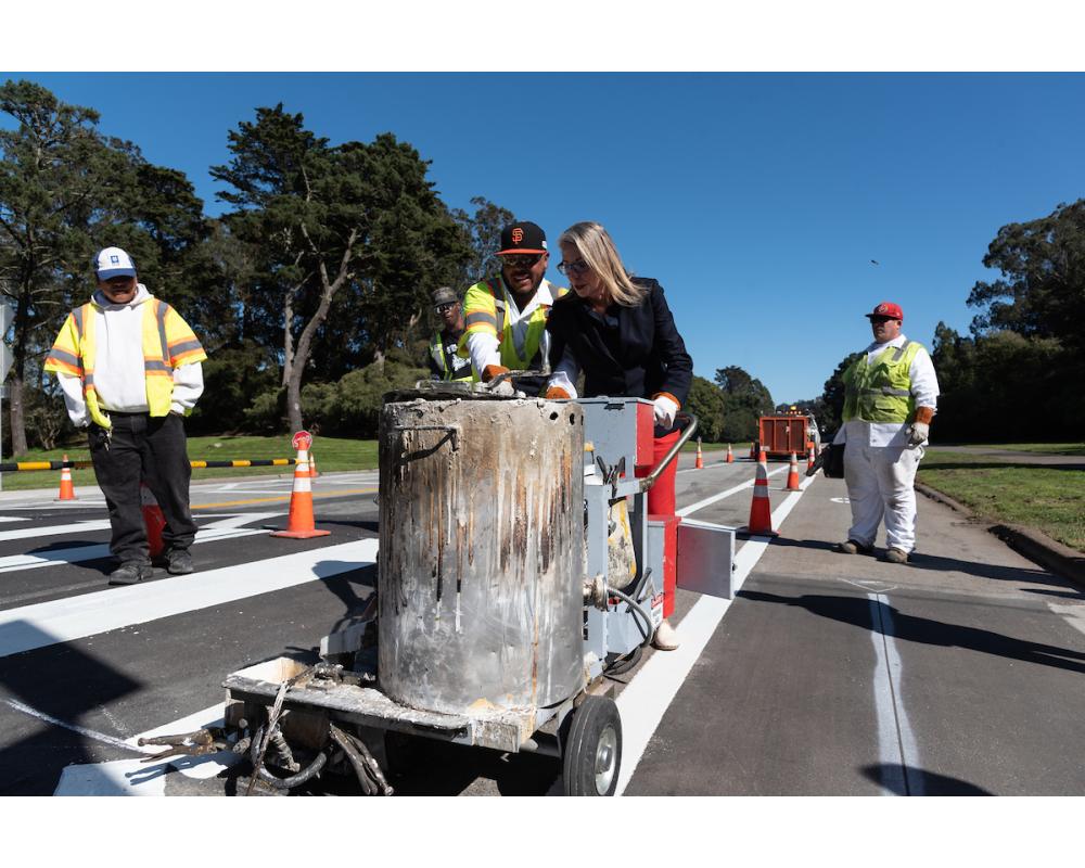 Supervisor Vallie Brown striping a crosswalk