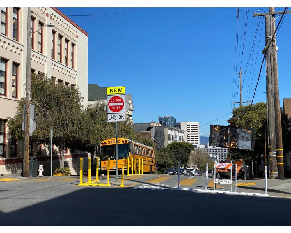 View of the traffic diverter at the intersection of Page and Webster streets, facing east toward Downtown