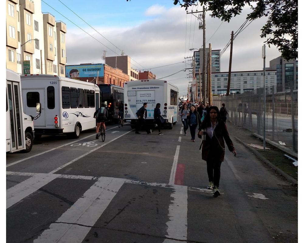 Photo of shuttles blocking and loading in the Townsend bike lane and no sidewalk for pedestrians - November 2016