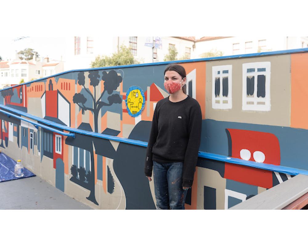 Artist Emily Fromm with her mural "East West Portal"