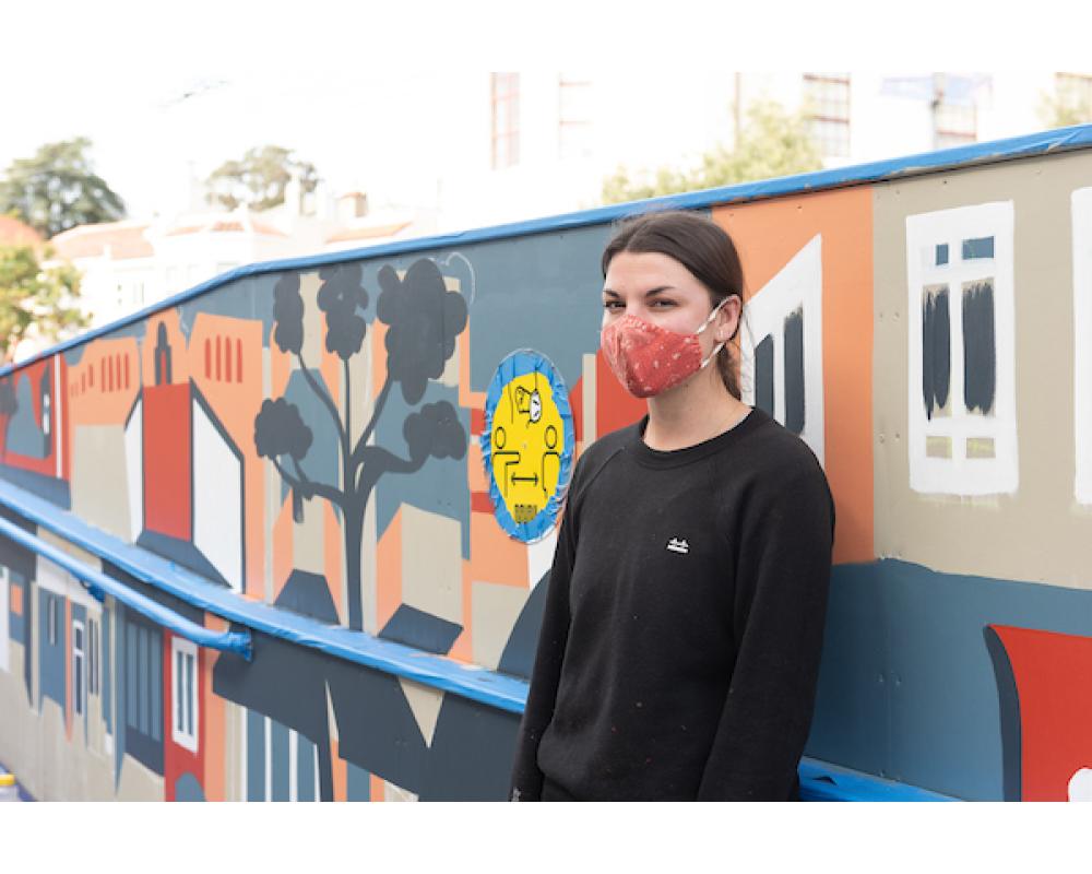 Artist Emily Fromm with her mural "East West Portal"