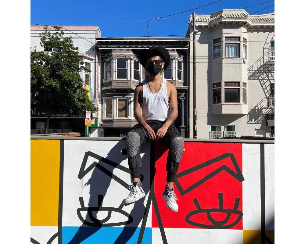 Simón Malvaez with his mural "Them (Ramp)"