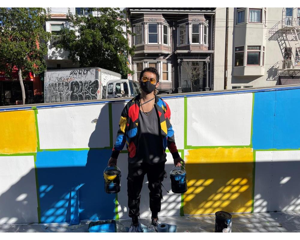 Simón Malvaez with his mural "Them (Ramp)"