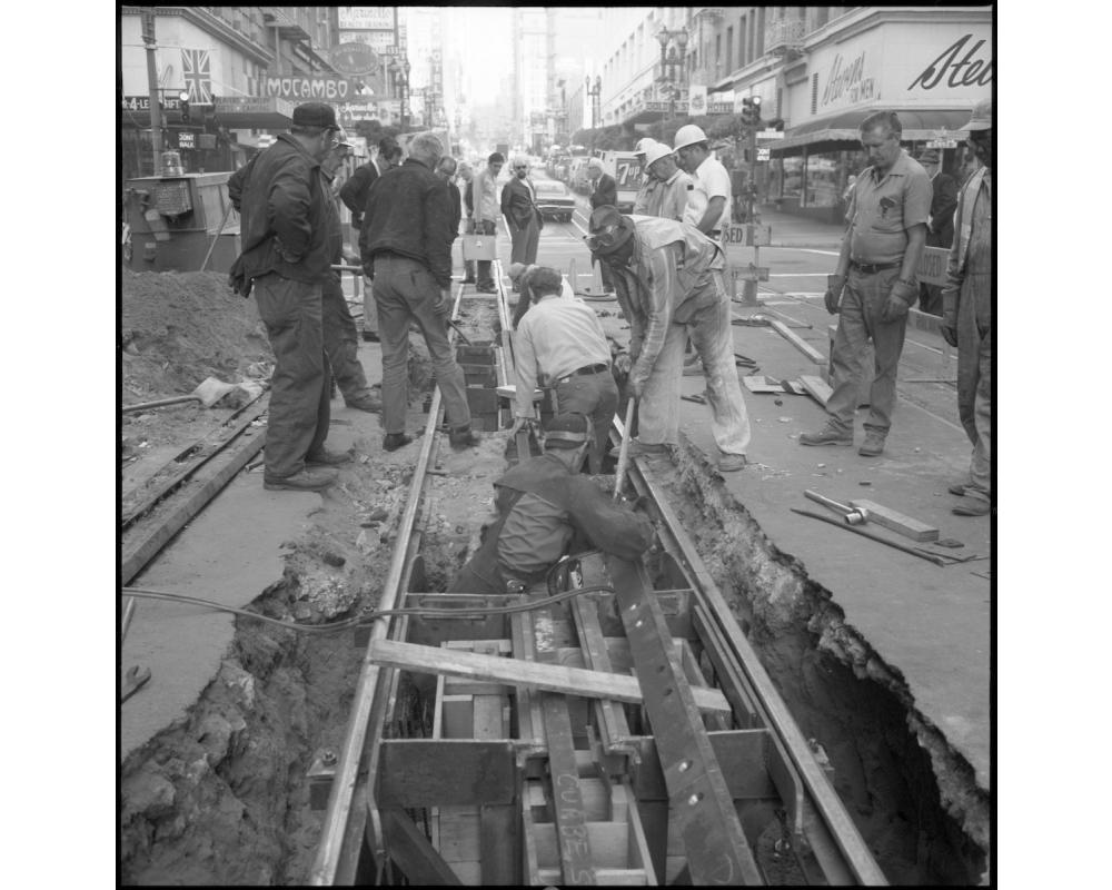  A track crew works to replace a depression beam and bumper bar 