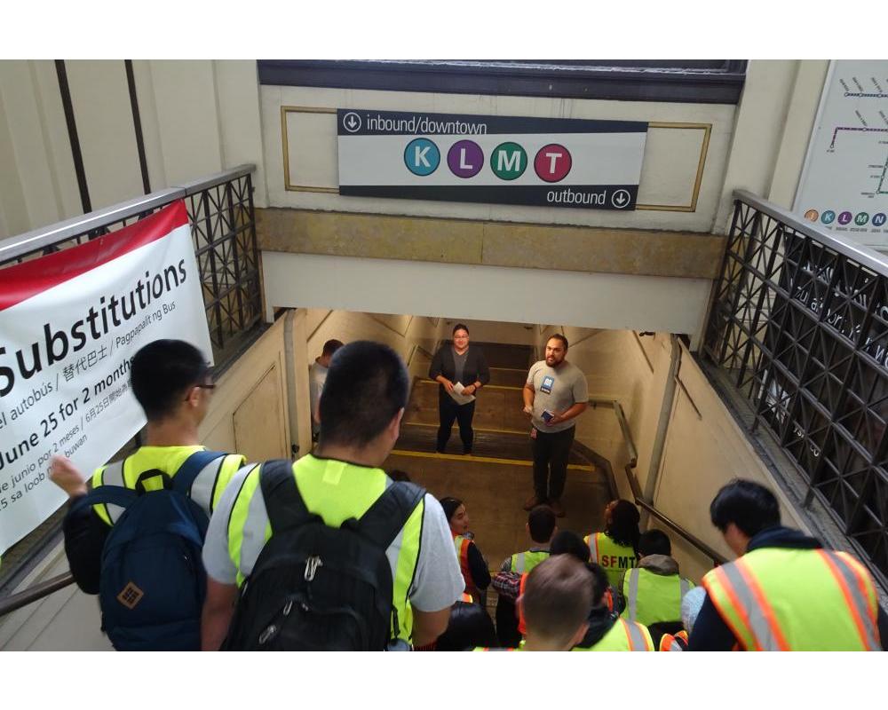 Photo of interns listening to presentation by STMFA staff in stairwell.