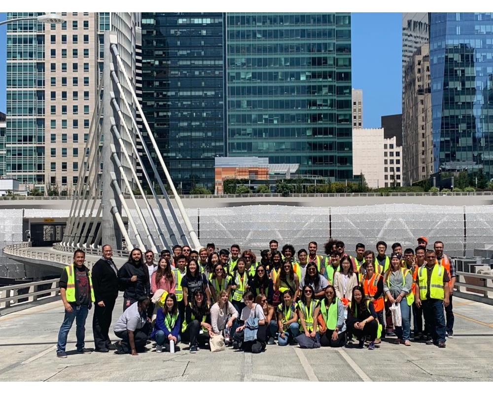 Photo of tour group on bridge with Salesforce Transit Center in the background.