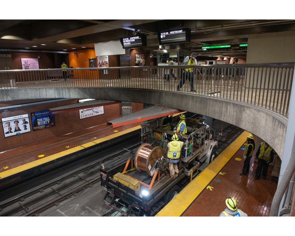 MOW crews install new wires while custodians complete a deep clean of the Mezzanine at Castro Station
