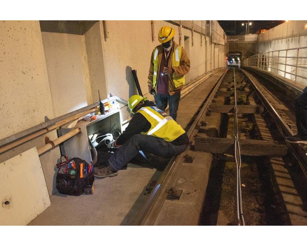 SFMTA Overhead Lines and Underground department perform preventative maintenance on a utility cable box at the Duboce Portal