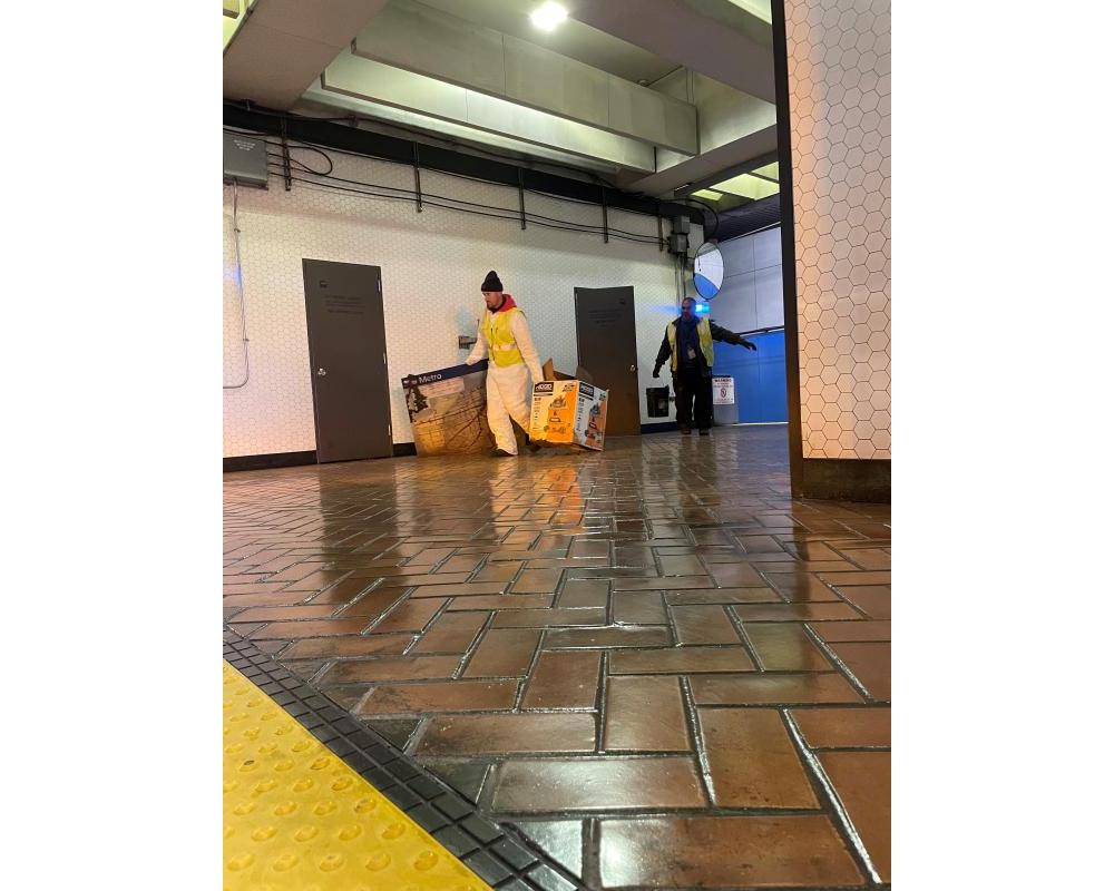 MOW employees clean out a mechanical room at Montgomery Station 