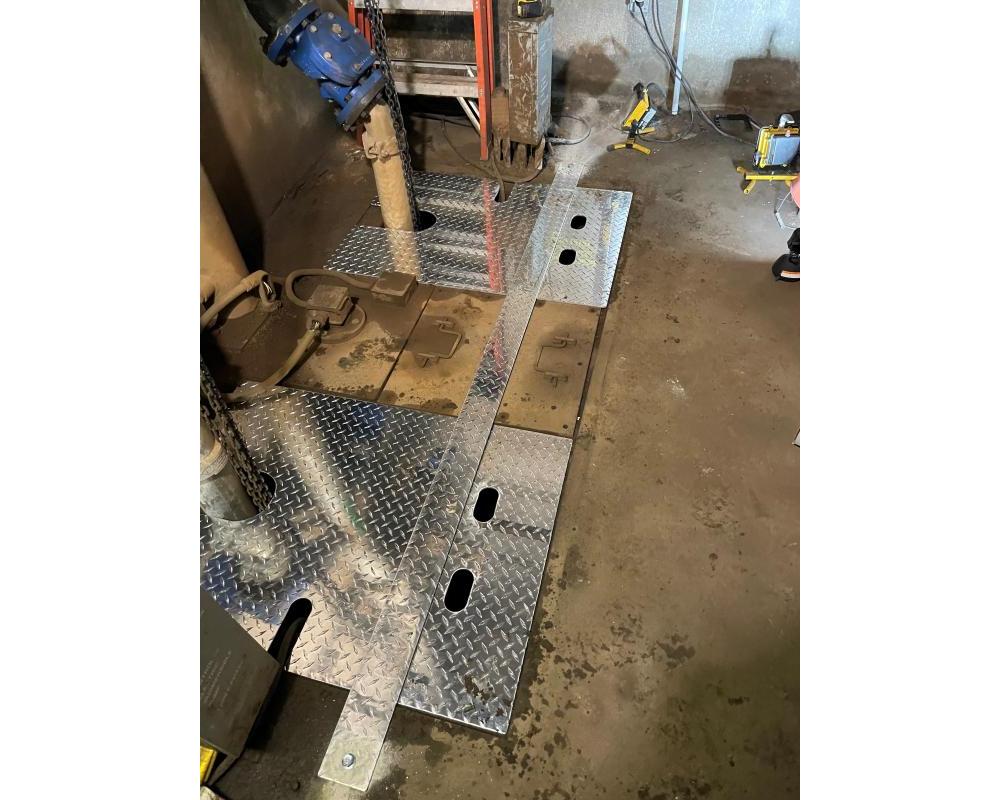 MOW workers install a new custom sump cover during Fix It Week