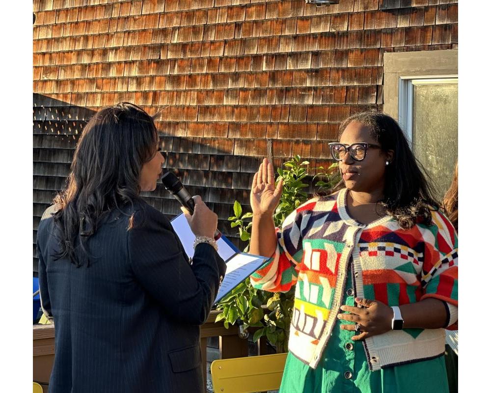 San Francisco Mayor London Breed and Board of Directors member Dominica Henderson facing each other at a swearing in ceremony. 