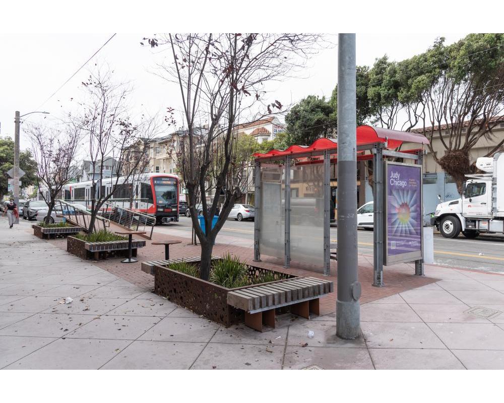 An N Judah approaches a transit shelter
