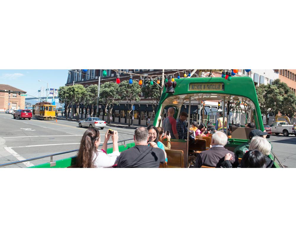 Riders on the open-topped boat style Blackpool streetcar on the Embarcadero