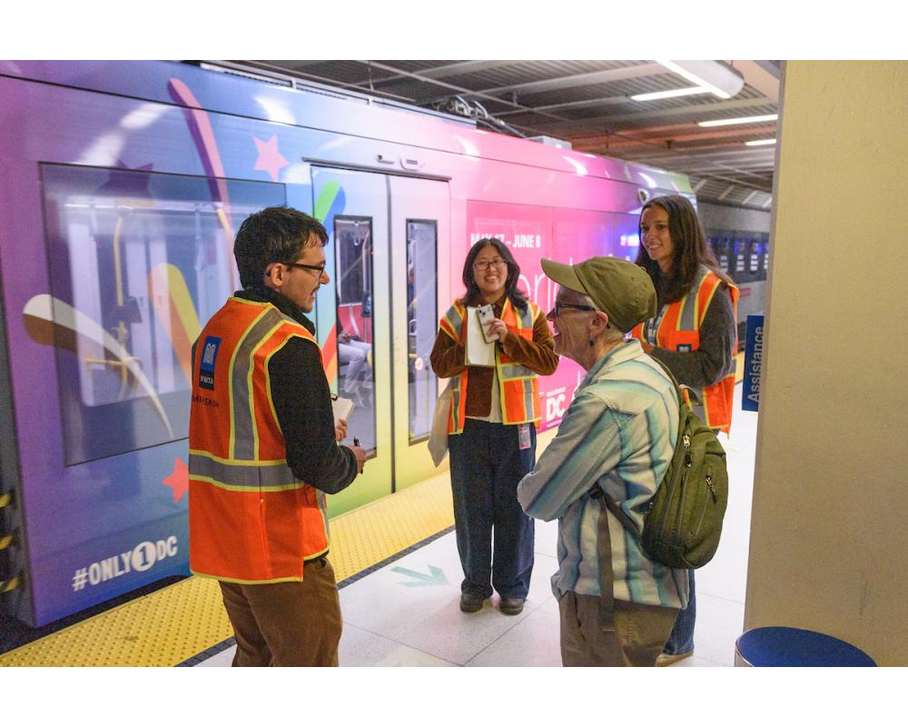 Three interns interview and member of the public on the Van Ness station platform.