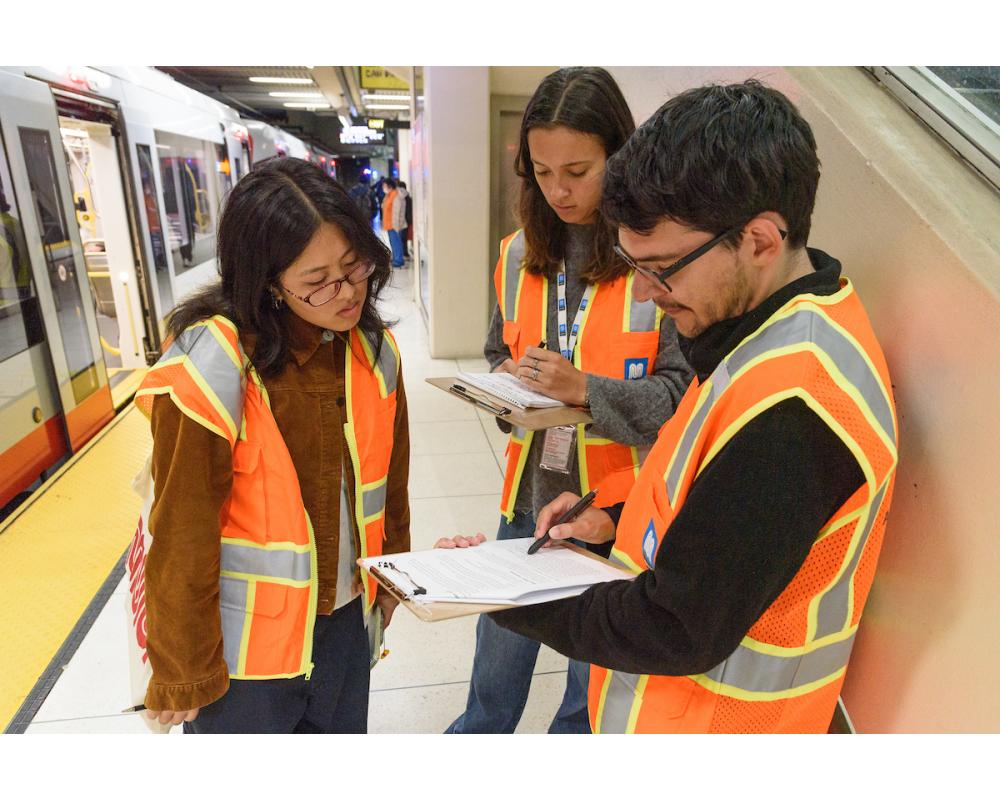 Interns reviewing important notes on a clipboard.