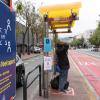 Signage and ground markings at Muni stops encourage physical distancing.