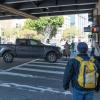 pedestrians walking in the crosswalk at 13th Street and Mission Street and a turning pick-up truck