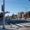 Image of woman crossing at a new crosswalk at Cook Street