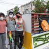 Simón Malvaez with friends in front of his mural "Them (Ramp)"