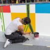 Simón Malvaez painting his mural "Them (Ramp)"