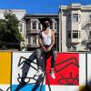 Simón Malvaez with his mural "Them (Ramp)"