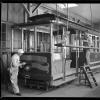  Two painters work on California Street Cable Car 15 in the paint shop