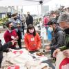 SFMTA staff hand out Muni bags to guests at the Geary Rapid ribbon cutting event