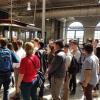 Photo of interns listening to presentation with cable car in background