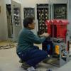 A man is kneeling in front a deck system piece inside a shops location.
