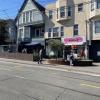 People enjoy a parklet in front of businesses