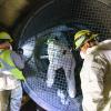 Crew members wearing safety gear in a Muni Metro tunnel check a ventilation system for Fix-It Week.