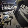 Two crew members hover over a range of materials to do subway and surface switch repairs during Fix-It Week.
