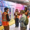 Three interns interview and member of the public on the Van Ness station platform.
