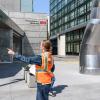 Intern pointing south at the Yerba Buena station entrance during site assessment.