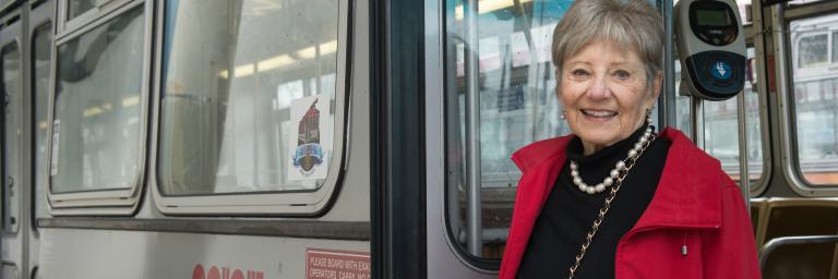 Image of woman smiling and exiting a MUNI bus