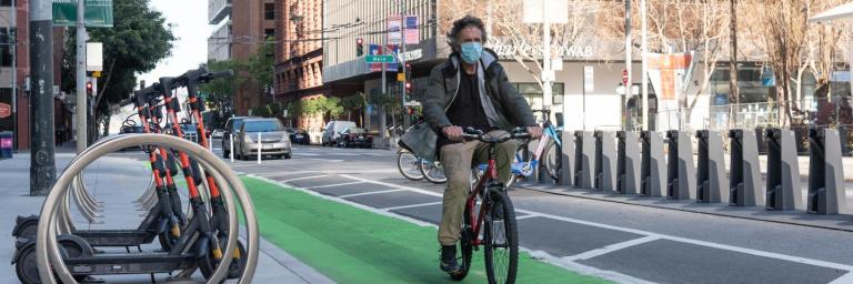 person biking in a protected bikeway on Howard Street