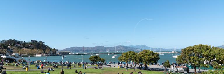 People enjoying views of Aquatic Park on a sunny day